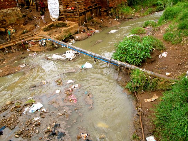 Water System Runs Past Open Sewage in Kibera