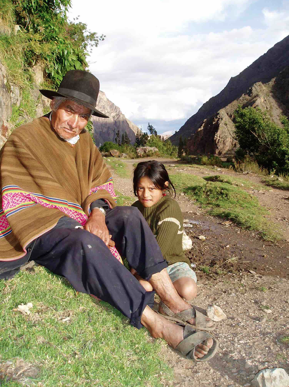 Grandfather and granddaughter rest alongside Peru's Inca Trail 